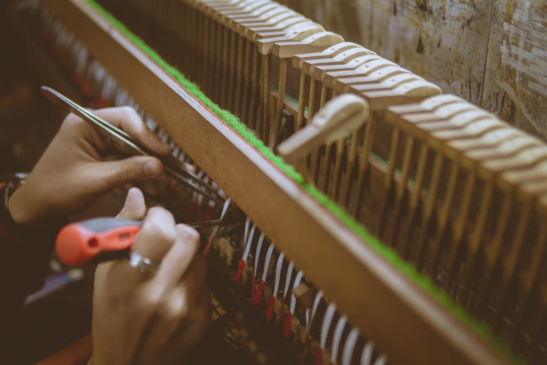 Hands repairing piano action